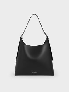 Minimalist and modern, this Hertha hobo bag offers excellent style mileage -- you will find yourself reaching for it all the time. Offering both style and functionality, this distinctive trapeze bag in timeless black can be dressed up or down according to your preferences and needs. With a roomy interior that can hold everything you need in a day, its minimalist design makes it suitable for both work and play. Its magnetic closure ensures both security and accessibility. Slouchy Hobo Bag, Trapeze Bag, Belt Ring, Charles Keith, Hobo Bag, Magnetic Closure, Sales Gifts, Trending Shoes, Minimalist Design