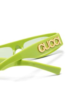 lime green acetate geometric frame green tinted lenses UV-protective lenses logo plaque at the arm straight arms and curved tips These glasses come with a protective case. Gucci Eyeglasses Women Green, Spring Designer Sunglasses With Mirrored Lenses, Modern Green Shield Sunglasses With Uva Protection, Designer Sunglasses With Uv Protection, Green Rectangular Sunglasses With Tinted Lenses, Designer Sunglasses With Uv Protection For Spring, Green Rectangular Tinted Sunglasses, Green Rectangular Sunglasses With Mirrored Lenses, Designer Anti-reflective Sunglasses For Summer