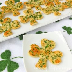 two white plates with shamrock shaped biscuits on them