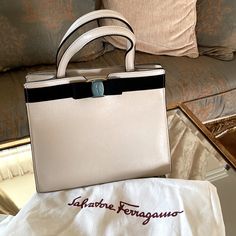 Ferragamo Satchel Handbag New With Tags Cream & Black Neutral Dustbag Included Hardware Covered & Protected Matte Gold & Leather Chain Designer Beige Office Bag, High-end Cream Shoulder Bag For Evening, High-end Cream Leather Bag, High-end Cream Satchel Shoulder Bag, Luxury Cream Shoulder Bag With Top Carry Handle, Luxury Cream Square Bag, Luxury Cream Satchel With Top Handle, Luxury Cream Top Handle Satchel, High-end Cream Bags With Detachable Handle