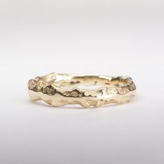 a close up of a gold ring on a white background