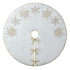 a white and gold christmas tree skirt with snowflakes on it