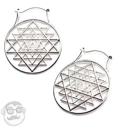 two metal earrings with geometric designs on them