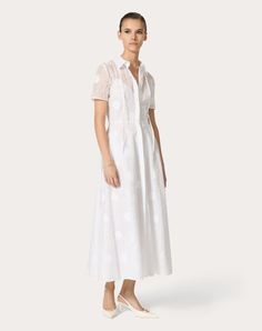 Daisy Organdis Midi Dress - Concealed front button fastening - Daisy Organdis (93% Cotton, 7% Polyester) - Muslin lining (100% Cotton) - Length: 130 cm / 51.1 in. from the shoulders in an Italian size 40 - Sleeve length: 45 cm / 17.7 in. from the centre back in an Italian size 45 - The model is 176 cm / 5'9" tall and wears an Italian size 40 - Made in Italy The look of the model is completed by a Valentino Garavani VLOGO MOON Bag and Valentino Garavani The Bold Edition Shoes. Luxury White Dress With Buttons, Elegant Short Sleeve Dresses With Covered Buttons, Luxury Spring Dresses With Button Closure, Spring Luxury Dresses With Button Closure, White Workwear Dresses With Covered Buttons, Summer Formal Midi Dress With Covered Buttons, Formal Summer Midi Dress With Covered Buttons, Elegant Short Sleeve Shirt Dress With Covered Buttons, Luxury White Daywear Dress