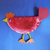 a red paper plate bird with hearts on its head and legs, sitting on a blue background