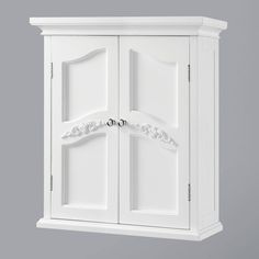 a white cabinet with two doors on the front and one door open to reveal an ornate design