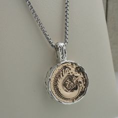 "Sterling Silver with Bronze Large Dragon Spirit Pendant Dragon Coin Pendant with Celtic Knot on side and back Dragon  pendant 7/8\" x 1.25\" Long  Side depth measures 7 mm  22.7 grams pendant and chain. 22\" Venetian Box Chain (Can substitute 16\", 18\" or 20\") This pendant is inspired by ancient Celtic coinage late 2nd/ 1st c. BC. Petrichor Dragon Spirit Pendant by Keith Jack Gift boxed with cleaning cloth. Imported from Canada. Ships in 3 to 5 days. (Selecting alternative chain length may de Sterling Silver Medallion Jewelry With Box Chain, Sterling Silver Box Chain With Round Pendant, Sterling Silver Round Box Chain Jewelry, Collectible Round Pendant Box Chain Jewelry, Luxury Silver Jewelry With Coin Pendant, Classic Stamped 925 Medallion Jewelry, Classic Oxidized Round Pendant Jewelry, Sterling Silver White Gold Coin Pendant Jewelry, Sterling Silver Box Chain Jewelry For Anniversary