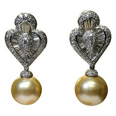 Maybe we are partial, but these earrings are absolutely incredible! They are newly made (never worn) in 18k gold and set with approximately 6.50cttw in H-I color and Vs1 to Si1 clarity round and oversized, calibrated baguette diamonds. The bottom golden South Sea pearls being 14.90mm are removable for less formal, daytime wear. Measurements 1 3/4” long with pearl attached and 1” long without and they measure .6” wide. Condition New, unworn condition. Golden Day, Baguette Diamond Earrings, Golden South Sea Pearls, Golden Days, Baguette Diamonds, Sea Pearl, South Seas, South Sea Pearls, Sea Pearls