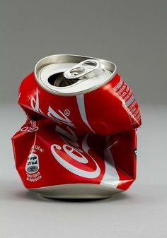 an open can of soda sitting on top of a table