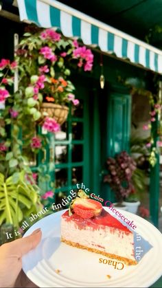 a piece of cake sitting on top of a white plate with pink flowers in the background