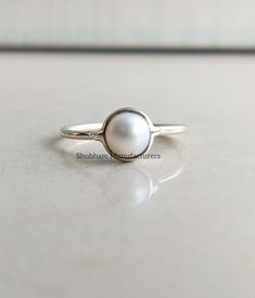 Natural White Pearl Round Cabochon 925 Sterling Silver Handmade Minimalist Ring PRODUCT DETAILS:- Material: 925 Sterling Silver Weight: 1.40 Grams (Approximate/Depends on Ring Size) GEMSTONE DETAILS:- Name: Pearl Color: White Size:6x6 mm Shape: Round Cut: Cabochon The silver ring in the photo is the one that you will be purchasing. Genuine sterling silver and Natural Pearl Gemstone. This is a simple and elegant piece of Handmade jewelry at a very affordable price! And this ring will be shipped i Dainty Stackable Sterling Silver Pearl Ring, Dainty Sterling Silver Pearl Ring For Everyday, Classic White Round Midi Rings, White Sterling Silver Dainty Midi Rings, Silver Minimalist Pearl Ring For Everyday Wear, White Sterling Silver Jewelry With Simple Design, Minimalist Stackable Sterling Silver Pearl Ring, Everyday Silver Pearl Ring, Simple White Sterling Silver Midi Rings