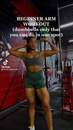 a woman standing in front of a gym wall with the words beginner arm workout dumbbells only that you can do in one spot