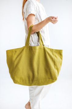 "This large linen bag is perfect for a long-awaited summer holiday, picnic, or trip to the beach. Made of soft heavyweight linen that feels lovely to the touch. Roomy enough for large towels along with other essentials. The bag has an extra linen lining, so it can easily withstand heavier items. * Which is your favorite color? Olive / Ocean / Terracotta. Beach bag approx. size: Height: 35 cm / 14\" Length: 45 cm / 18\" Width: 22 cm / 9\" Handles: 26 cm / 10\" (Strap drop length) \"Custom size av Green Canvas Bags For Summer, Linen Tote Beach Bag For Travel, Eco-friendly Linen Shoulder Bag For Beach, Eco-friendly Linen Canvas Bag For Beach, Summer Linen Canvas Bag For Travel, Eco-friendly Linen Canvas Beach Bag, Summer Linen Canvas Travel Bag, Everyday Rectangular Linen Beach Bag, Large Capacity Linen Canvas Bag For Travel