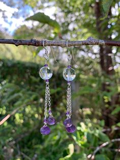 These earrings are made with 10 mm round faceted cut Rock Crystal Quartz beads accented with 2.5 mm rondelle faceted cut Amethyst & 2.5 mm round high polished silver beads. Dropped below them i suspended two varying lengths of 1.9 mm rolo chain from which i hung faceted onion cut Amethysts accented with 2.5 mm rondelle faceted cut Amethyst and 2.5 mm high polished round silver beads. They are finished with french wire earring components, measure 2 3/4" in total length and are made with .925 Ster Amethyst Faceted Beads Jewelry, Round Faceted Amethyst Beads Jewelry, Round Amethyst Jewelry With Faceted Beads, Faceted Amethyst Dangle Jewelry, Faceted Amethyst Earrings As A Gift, Faceted Amethyst Drop Earrings, Faceted Amethyst Round Jewelry, Faceted Amethyst Earrings For Gift, Round Amethyst Jewelry Making Material