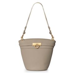 The timeless and trend-setting design of the Unlocked Bucket Bag is a must-have. It can be worn by its adjustable, removable shoulder strap or elegantly draped over your shoulder with an alternative woven strap. With its spacious interior, it's a wardrobe staple for your everyday adventures. Designer Everyday Bucket Satchel Bag, Luxury Bucket Satchel With Removable Pouch, Designer Bucket Hobo Bag With Gold-tone Hardware, Luxury Bucket Bag With Gold-tone Hardware Satchel, Designer Bucket Bag Satchel With Gold-tone Hardware, Designer Bucket Bag With Gold-tone Hardware, Chic Everyday Luxury Satchel Bag, Designer Bucket Bag With Detachable Strap For Everyday Use, Beige Crossbody Bags For Everyday Luxury