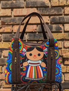 Beautifully handcrafted Mexican print purse. Mexican doll and colorful print make for a purse that is sure to catch everyone's eye. Made of leather, its large size is perfect for any occasion. Mexican Print, Mexican Purse, Mexican Doll, Printed Purse, Purses And Handbags, Print Making, Colorful Prints, Large Size, Shoulder Bags