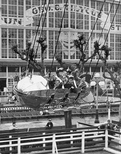 black and white photograph of people riding on a roller coaster