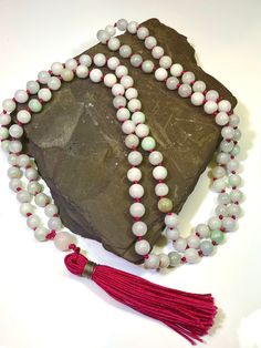 108 beaded natural Jadeite Mala Necklace  Gems: 506ct Jadeite 8mm plain round gemstones and 10.3 Rose Quartz Guru bead Length 24" inches  A Mala Necklace Mala Beads are more than just pretty necklaces. Each element of a Mala Necklace carries a meaning. Learn more about each part of a Mala Necklace and how it can help you on your own journey of meditation and intention setting. 108 Beads Malas always have 108 Beads. According to traditional Buddhism, 108 represents the number of mortal desires of Spiritual Jade Jewelry With 108 Beads, Spiritual Hand-strung Jade Beaded Necklace, Spiritual Single Strand Jade Beaded Necklace, Jade Beaded Necklaces With Gemstone Beads For Meditation, Single Strand Jade Beaded Necklace With Round Beads, 8mm Jade Beads For Spiritual Use, Jade Bead Necklaces For Meditation, Hand-strung Jade Necklaces With Round Beads, Hand-strung Round Jade Bead Necklaces