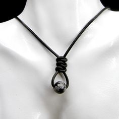 ABOUT THIS ITEM >  Snowflake Obsidian Gemstones >  Hand Knotted Black Leather Cord >  Surgical Stainless Steel Connectors >  Surgical Stainless Steel Lobster Claw Clasp The perfect accessory for adding a little fun to your day or any outfit. It goes well with almost everything!   It features a beautiful obsidian gemstone, quality 2mm diameter quality soft leather cord and surgical stainless steel lobster claw clasp! The hand tied knot in the leather not only adds to the refined and stylish look Leather Cord Necklace, Leather Corded Necklace, Snowflake Obsidian, Cord Necklace, Soft Black, Leather Cord, Matching Earrings, Lobster Claw, Favorite Jewelry