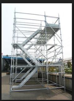 a large metal structure sitting on top of a sidewalk