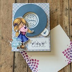 a close up of a greeting card on a wooden table with two cards and envelopes