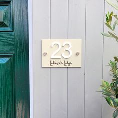 a house number sign on the side of a door