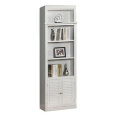 a white bookcase with three shelves and pictures on the top one shelf is open