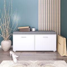 a white shoe is sitting on the floor next to a cabinet and vase with branches in it