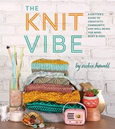 the knitt vibe book is sitting on top of a table next to other items