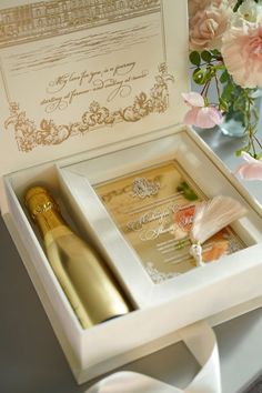 a wedding card and champagne bottle in a box