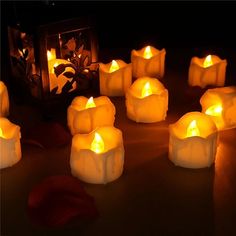 many lit candles sitting on top of a table