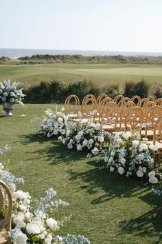 an outdoor ceremony setup with chairs and flowers on the lawn, overlooking the golf course