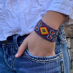 Handmade Purple Beaded Bracelet, Handwoven, Loom, Casual Wristband Jewelry 1.25 x 7.5 Inch Sparkly seed beads where used to create this beautiful beaded bracelet. *Casual Wear Beaded Bracelet *Native American Inspired Design *The bracelet can be secured at one of three lengths with a beaded button. *Handmade in Guatemala Beaded Brown Friendship Bracelets As Gift, Brown Beaded Friendship Bracelets As Gift, Hippie Style Braided Beaded Bracelets, Hippie Style Colorful Beaded Bracelets As Gift, Handmade Adjustable Orange Cuff Bracelet, Handmade Orange Adjustable Cuff Bracelet, Southwestern Adjustable Beaded Bracelets As Gift, Southwestern Style Adjustable Beaded Bracelets As Gift, Bohemian Orange Beaded Bracelets For Friendship