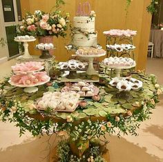 a table topped with lots of cakes and desserts