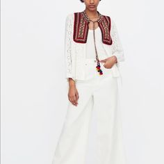 Love Embroidered Bib With Pom Pom Ties... Bohemian Chic White Cotton Cardigan With Floral Embroidery, Spring Embroidered White Cardigan, White Embroidered Spring Cardigan, White Embroidered Cardigan For Spring, Chic White Outerwear With Floral Embroidery, White Embroidered Cotton Cardigan, White Bohemian Cardigan With Floral Embroidery, White Floral Embroidered Outerwear For Summer, White Floral Embroidered Summer Outerwear