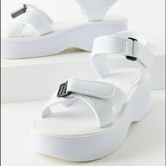 Jayna Sandal Features A Plushy Silhouette And Secure Strapping System. Platform Sole With A Cushioned Footbed Topped With Hook-And-Loop Straps That Adjust At The Toes And Ankle For An Easy On/Off. Exclusively Available At Urban Outfitters - 100% Rubber - Spot Clean - True To Size - Platform Height: 1.5" White Ankle Strap Sport Sandals For Summer, White Ankle Strap Sport Sandals For Beach, White Platform Sport Sandals For Beach, White Synthetic Sport Sandals For Summer, White Sport Sandals With Textured Footbed And Ankle Strap, White Ankle Strap Sport Sandals With Textured Footbed, White Sport Sandals For Spring And Summer, Urban Outfitters Open Toe Synthetic Sandals, Urban Outfitters Sandals With Round Toe For Summer