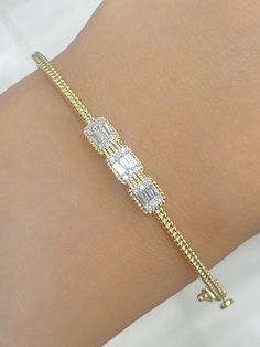 100% Genuine Natural 0.25 CTW Diamond / Baguette Bangle Bracelet in 14 KT    ITEM CONDITION : BRAND NEW . DIAMOND CARAT : 0.25 CTW DIAMOND CUT : ROUND BRILLIANT CUT. DIAMOND COLOR : G-H DIAMOND CLARITY : SI DIAMOND SYMMETRY : EXCELLENT DIAMOND SETTING : PRONG SETTING ITEM NO : 87771 GOLD CARAT : 14 KT  SUGGESTED RETAIL VALUE : $2025.00 Match it with an equally beautiful Chain, Charm & Earring – Available in our Store! ALL ITEMS ARE BRAND NEW! Our Diamonds are 100% Natural and are neither Treated Diamond Bangles, Diamond Bracelet Design, Diamond Baguette, Diamond Bangles Bracelet, Bracelet Design, Diamond Settings, Fine Jewelry Bracelets, Diamond Bangle, Diamond Carat