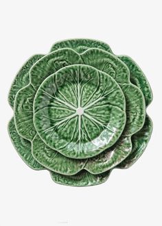 four green plates stacked on top of each other in the shape of a cabbage flower