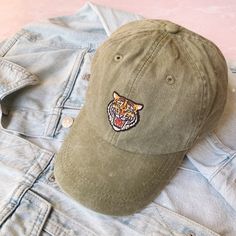 ROAR!  This is one savage kitty!  Tiger head patch baseball hat / baseball cap is perfect for adding a bit of attitude just about anywhere!  Wildflower + Co. baseball hats feature your fave embroidered patch & choice of hat color!   Hats are 100% cotton pigment dyed for a soft, sun faded color with an adjustable leather strap with brass buckle in the back.  Low-profile, 6 panel fit.   Details: ♥ Hats are from Adams & include their logo on the back strap.  They feature Cool Crown construction wit Casual Snapback Fitted Hat With Embroidered Patch, Casual Fitted Hat With Embroidered Patch, Casual Fitted Cap With Embroidered Patch, Casual Baseball Cap With Embroidered Patch And Flat Bill, Casual Baseball Cap With Embroidered Patch, Casual Embroidered Patch Hat For Baseball Season, Casual Baseball Cap With Patches, Casual Cap With Embroidered Patch, Casual Fitted Baseball Cap With Embroidered Patch