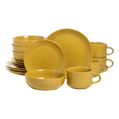 yellow dinnerware set with cups and saucers on the side, isolated against a white background