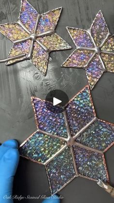 someone is working on an ornament that looks like stars