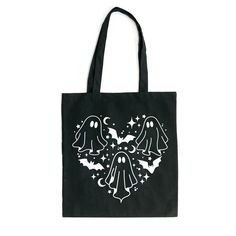 a black tote bag with two ghost heads on it and stars in the background