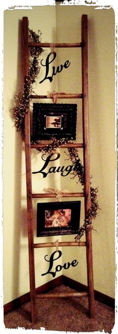 a wooden ladder with three pictures on it and the words live laugh love written in cursive writing