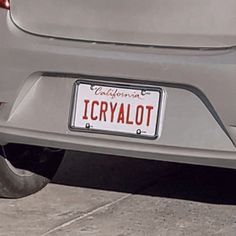 the license plate is on the back of a silver car that says icrysalot