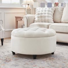 a white ottoman sitting on top of a rug in a living room