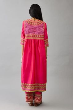 Fuchsia silk anarkali with multicolour thread embroidered geometric motifs, embellished by mirrorwork. Comes with contrast pant. - Aza Fashions Bohemian Pink Salwar Kameez With Mirror Work, Bohemian Embroidered Pink Salwar Kameez, Bohemian Pink Embroidered Salwar Kameez, Bohemian Pink Chanderi Dress, Pink Dress With Embroidered Border For Festive Occasion, Pink Dress With Embroidered Border For Festivals, Bohemian Pink Salwar Kameez With Resham Embroidery, Pink Anarkali Dress With Embroidered Border, Bohemian Pink Anarkali Set For Diwali