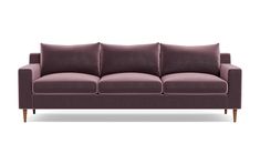 a purple couch sitting on top of a white floor