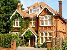 a large brown house with lots of windows