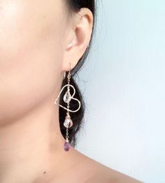 This earring is perfect to compliment any spring outfit with its purple ombré gemstone dangles and floating heart shape component. I used amethyst , pink amethyst and crystal quartz in this design. Hand shaped heart charm were slightly hammered for textures and shine, measured about 1.25 inches in size. Earring is about 3 inches long including ear wires. Handmade gold filled French ear wires. Purple Teardrop Chandelier Earrings As Gift, Dainty Heart-shaped Earrings For Parties, Single Heart Earring For Wedding, Wedding Heart Drop Earrings Single Piece, Anniversary Teardrop Earrings With Heart Charm, Dangle Heart Beads Jewelry For Party, Heart-shaped Crystal Earrings For Gift, Teardrop Earrings With Heart Charm For Anniversary, Sterling Silver Dangle Heart Earrings For Party