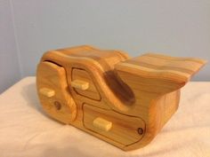 a wooden object sitting on top of a white blanket